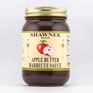 A jar of Shawnee Brand Apple Butter Barbecue Sauce with a label featuring an illustrated apple, against a plain background.