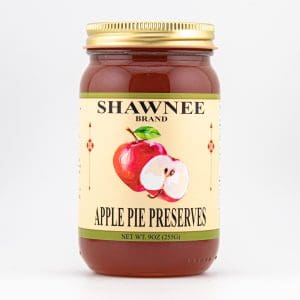A Shawnee Brand jar of apple pie preserves with an illustration of apples on the label, against a plain white background.