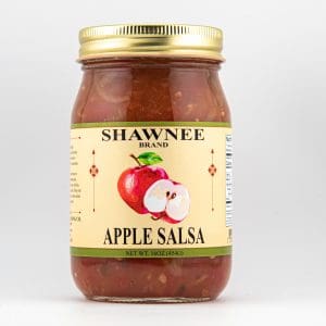 A jar of Shawnee Brand apple salsa with a golden lid and illustrated apple on the label, against a plain background.