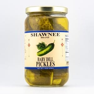 A jar of Shawnee brand baby dill pickles, 16oz (454g), featuring a label with a pickle illustration and nutritional information on the side.