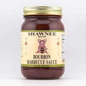 A jar of Shawnee Brand Bourbon Barbecue Sauce featuring a pig illustration, with an 18 oz label and nutrition information visible on the side.