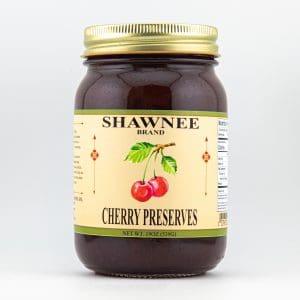 A jar of Shawnee Brand cherry preserves with a gold lid, featuring an illustrated label with cherries. Net weight: 19 oz (539g).