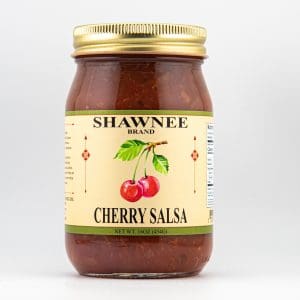 A jar of Shawnee Brand Cherry Salsa with a gold lid and illustrated cherries on the label, weighing 16 ounces (454g).