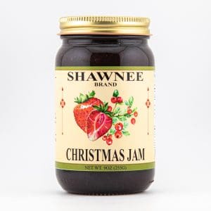A jar of Shawnee Brand Christmas Jam featuring strawberries and cranberries on the label. Contains 9 oz (255g) with a gold lid.