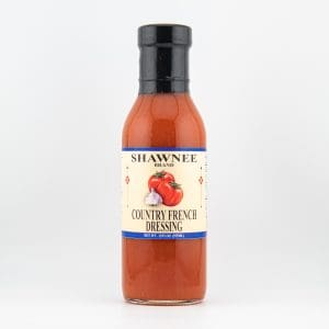 A bottle of Shawnee Brand Country French Dressing, featuring a label with tomato and garlic artwork, on a plain white background.