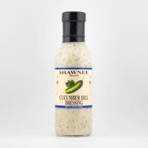 A bottle of Shawnee Brand Cucumber Dill Dressing with a black cap and label featuring a cucumber illustration, set against a white background.