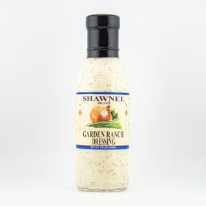 A bottle of Shawnee Brand Garden Ranch Dressing is displayed against a plain background, featuring images of onions and herbs on the label.