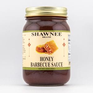 A jar of Shawnee Brand Honey Barbecue Sauce with honeycomb illustration on a white background. Contains 18 oz (504g) of sauce.