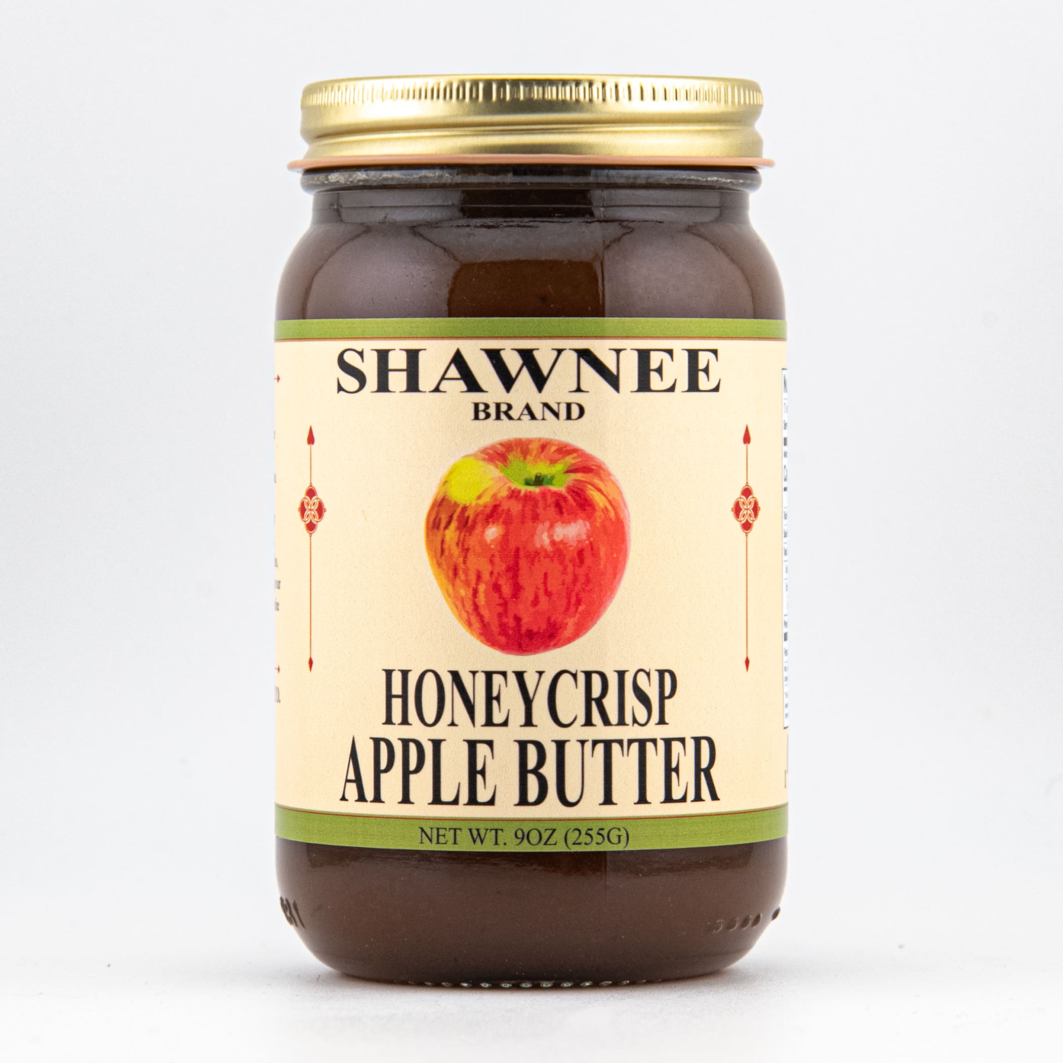 A jar of Shawnee Brand Honeycrisp Apple Butter with a golden lid and illustrated apple on the label. Contains 9 oz (255g).
