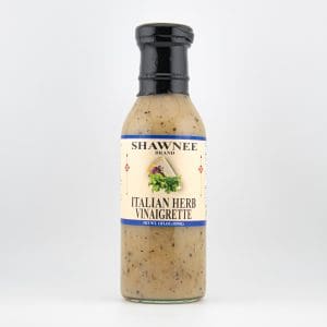 Bottle of Shawnee Brand Italian Herb Vinaigrette dressing on a plain white background, featuring an illustrated label with herbs and a blue border.