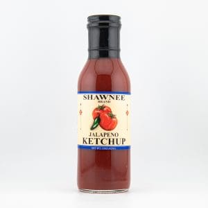 Bottle of Shawnee Brand Jalapeno Ketchup with a tomato and pepper illustration on the label, against a plain white background.
