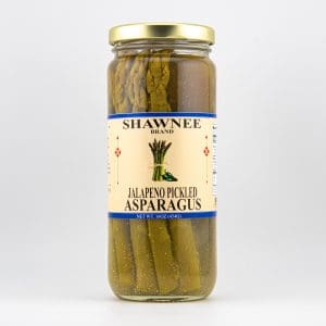 A jar of Shawnee Brand Jalapeno Pickled Asparagus with a beige label and blue accents, containing green asparagus spears.