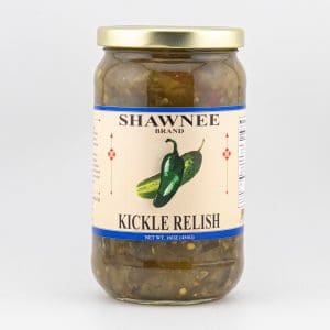 A jar of Shawnee Brand Kickle Relish with a gold lid, featuring illustrated cucumbers and peppers on the label, against a plain background.