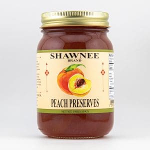 A jar of Shawnee brand peach preserves with a colorful label, featuring an illustration of peaches. The jar contains 19 ounces.
