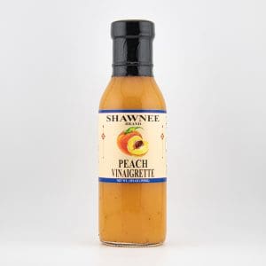 A bottle of Shawnee Brand Peach Vinaigrette with a peach illustration on the label, set against a plain white background.