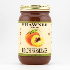 A jar of Shawnee Brand Peach Preserves, featuring a label with an illustration of a sliced peach, set against a white background.