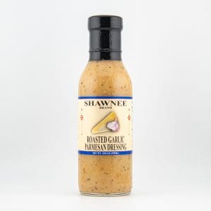 A bottle of Shawnee Brand Roasted Garlic Parmesan Dressing with a black cap against a plain white background.