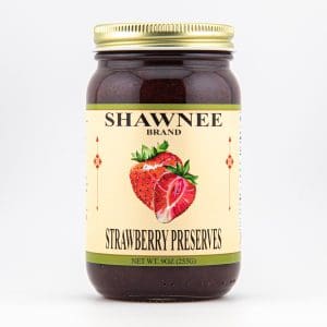 A jar labeled "Shawnee Brand Strawberry Preserves," featuring strawberries on the front. The jar contains 9 oz (255g) of preserves.
