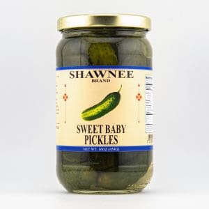 A jar of Shawnee Brand Sweet Baby Pickles, featuring a clear label with a cucumber illustration, containing pickles in brine, on a white background.