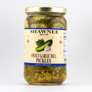 A 16-ounce jar of Shawnee Brand Sweet Garlic Dill Pickles with cucumbers and garlic depicted on the label, set against a plain background.