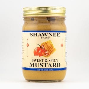 A jar of Shawnee Brand Sweet & Spicy Mustard with a label featuring a pepper and honeycomb design against a plain background.