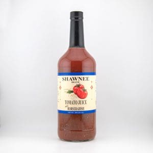 A large bottle of Shawnee Brand tomato juice with horseradish, featuring a light-colored label with tomatoes and a black cap.