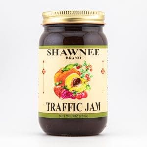 A jar of Shawnee Brand Traffic Jam, featuring a colorful fruit illustration on the label. The jar contains 9oz (255g) of jam.
