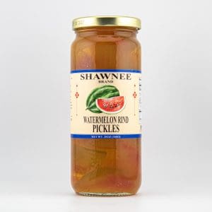 A clear glass jar labeled "Shawnee Brand Watermelon Rind Pickles" with a gold lid and an illustrated watermelon slice on a white background.