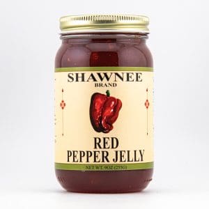 A jar of Shawnee Brand Red Pepper Jelly with a picture of a red pepper on the label, against a plain white background.