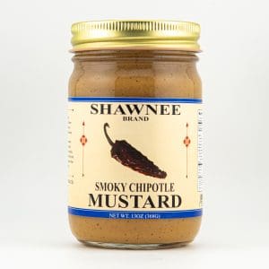 A jar of Shawnee Brand Smoky Chipotle Mustard with a gold lid and label featuring a chipotle pepper illustration on a white background.
