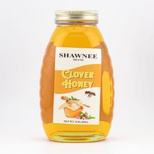 A jar of Shawnee Brand Clover Honey with a golden hue and bee illustration on the label, weighing 1 lb (454g).