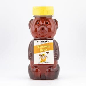 Honey bottle shaped like a bear with a yellow cap. Labeled "Shawnee Brand Wildflower Honey." White background.