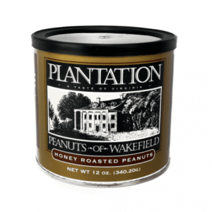 A tin can labeled "Plantation Peanuts of Wakefield," featuring an illustration of a historical building, contains 12 oz of honey roasted peanuts.