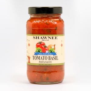 A jar of Shawnee brand all-natural tomato basil pasta sauce with a red tomato and basil design on the label.