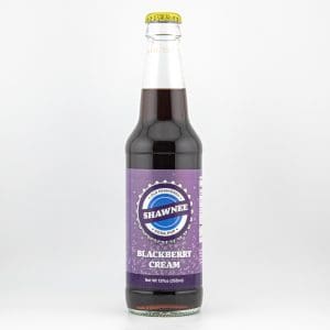 A bottle of Shawnee Blackberry Cream Soda with a purple label, featuring a vintage design. Contains 12 fl oz (355 ml).
