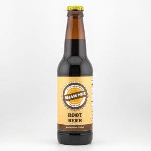 A bottle of Shawnee Root Beer with a yellow label featuring "Shawnee" in a circle, against a simple, light background.