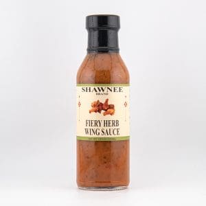 A bottle of Shawnee Brand Fiery Herb Wing Sauce with a clear label, displayed against a plain white background.