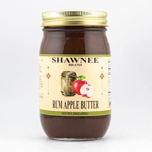 A 19 oz jar of Shawnee brand Rum Apple Butter. The label features an illustration of apples and a barrel, with nutritional information on the side.