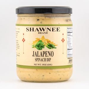 A jar of Shawnee brand Jalapeno Spinach Dip with a black lid and beige label featuring chips and greens. Net weight 15oz (424g).