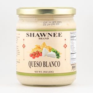 A jar of Shawnee Brand Queso Blanco, featuring a label with cheese, tomatoes, and chips. Net weight is 15 ounces (424 grams).