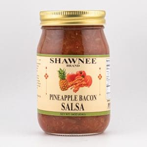 A jar of Shawnee Brand Pineapple Bacon Salsa with a golden lid. The label features illustrations of pineapple and bacon on a light background.