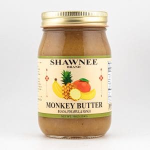 A jar of Shawnee Brand Monkey Butter featuring banana, pineapple, and mango on the label, against a plain white background.
