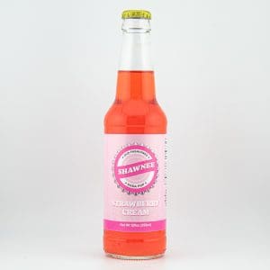 A bottle of Shawnee Strawberry Cream soda pop with a pink label sits against a plain white background.