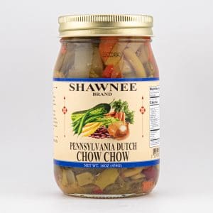 A jar of Shawnee Brand Pennsylvania Dutch Chow Chow, featuring vibrant vegetables on the label, contains a pickled vegetable medley.