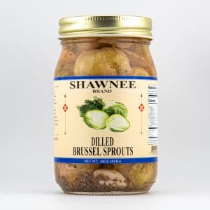A jar of Shawnee Brand Dilled Brussels Sprouts with a gold lid, featuring nutritional information and images of Brussels sprouts on the label.