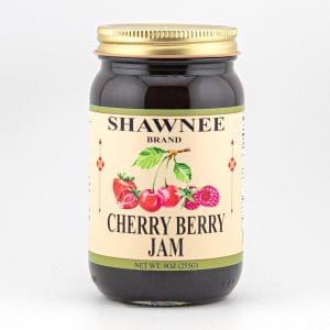 A jar of Shawnee Brand Cherry Berry Jam with an illustrated label showing cherries and berries, set against a plain, white background.