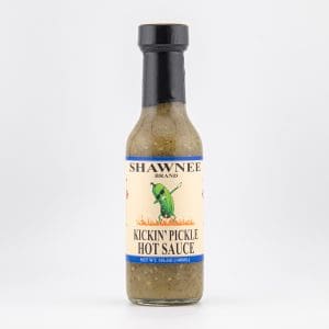 Shawnee Brand Kickin' Pickle Hot Sauce bottle displayed on a white background, featuring a green pickle character and flames on the label.
