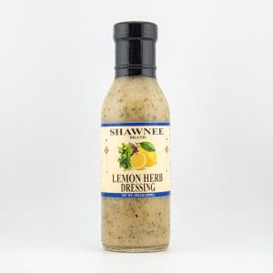 A bottle of Shawnee Brand Lemon Herb Dressing with a black cap, featuring a label with lemon and herb imagery on a white background.