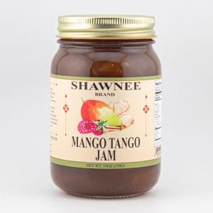 A jar of Shawnee Brand Mango Tango Jam with a gold lid, featuring mango, ginger, and raspberry illustrations on the label.