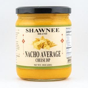 A 15 oz jar of Shawnee Brand "Nacho Average" cheese dip, featuring tortilla chips on the label, with nutritional information on the side.